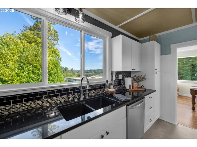 a kitchen with a sink and a large window