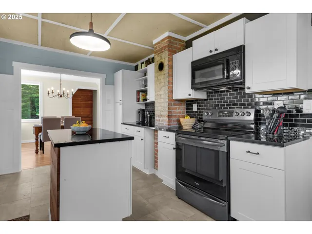 a kitchen with stainless steel appliances granite countertop a sink and a microwave