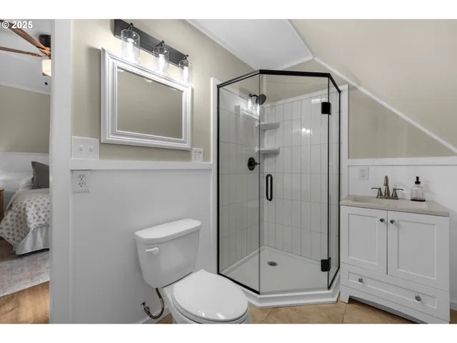 a bathroom with a shower a mirror and a sink