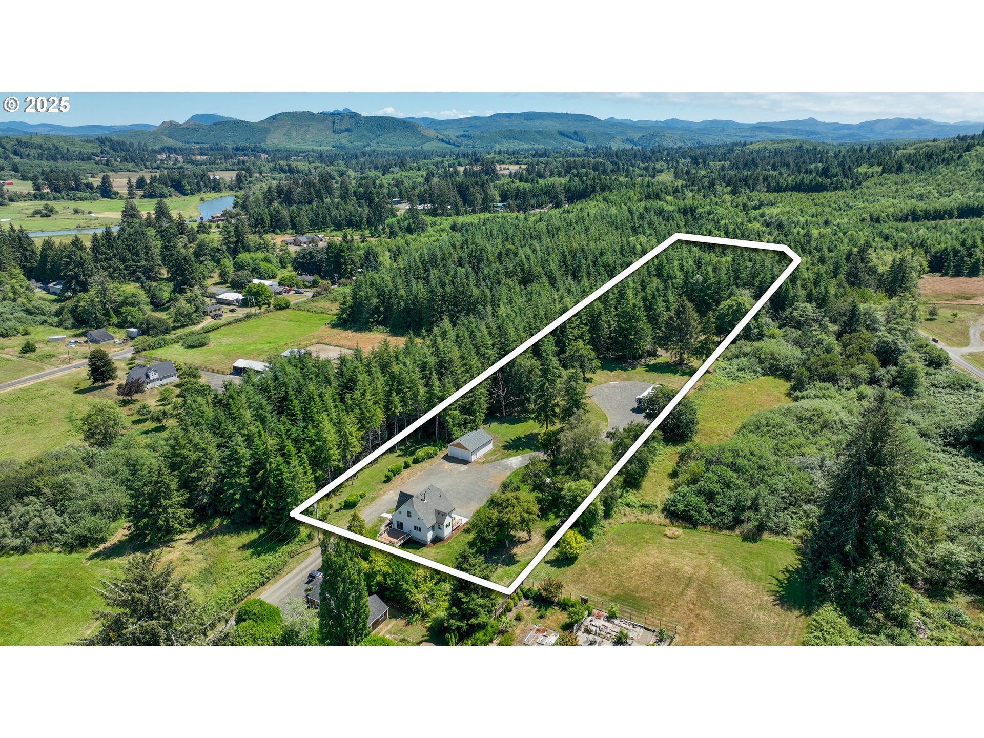 90635 Spring Road Astoria, OR 97103 - Photo 5 of 38 a view of a city with lush green forest