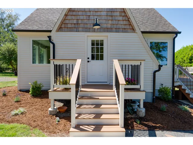 a front view of a house with stairs and furniture