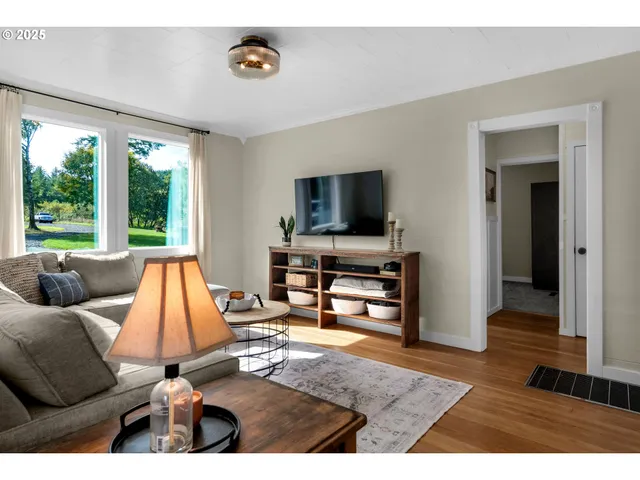a living room with furniture and a flat screen tv