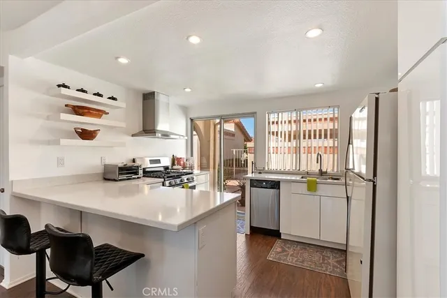 a kitchen with a sink a stove and cabinets