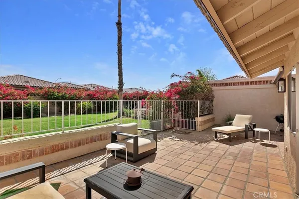 a garden view with a seating space and fir pit