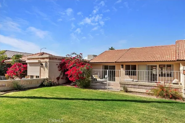 a front view of a house with a yard table and chairs