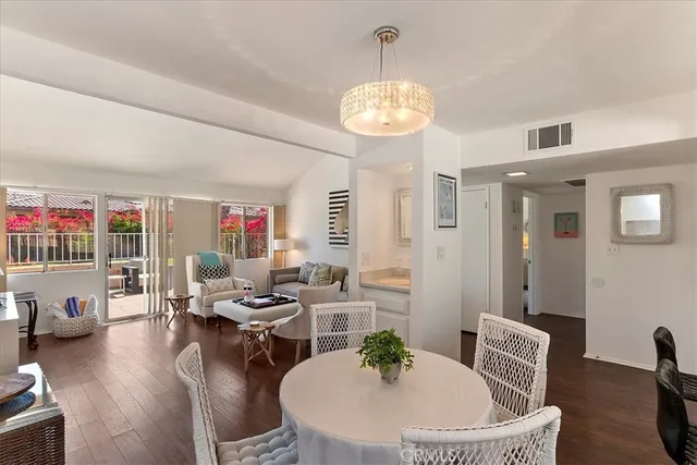 a living room with furniture kitchen and a chandelier