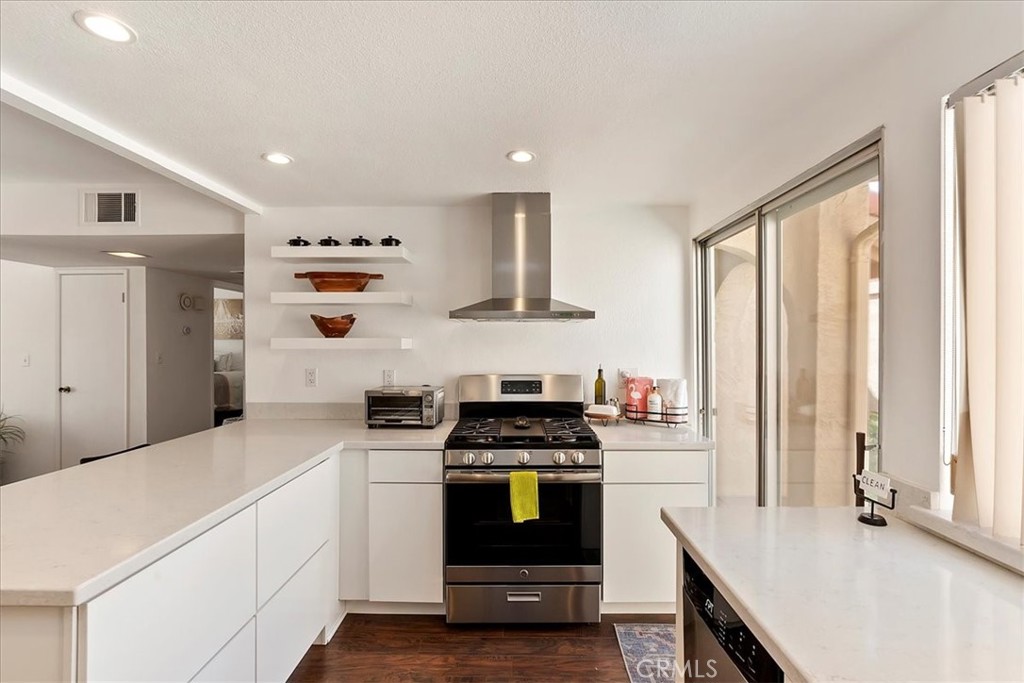 82297 Cochran Drive Indio, CA 92201 - Photo 10 of 32 a kitchen with a stove and a refrigerator