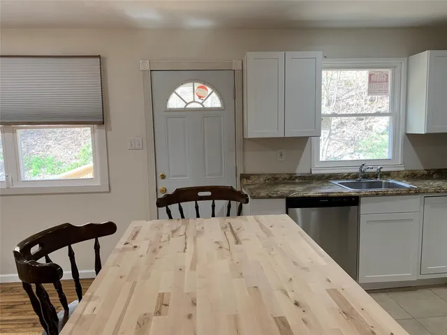 a kitchen with a window a sink and a cabinets