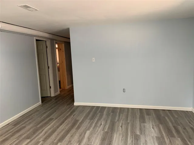 a view of a room with wooden floor