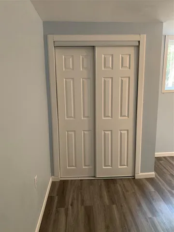 an empty room with wooden floor