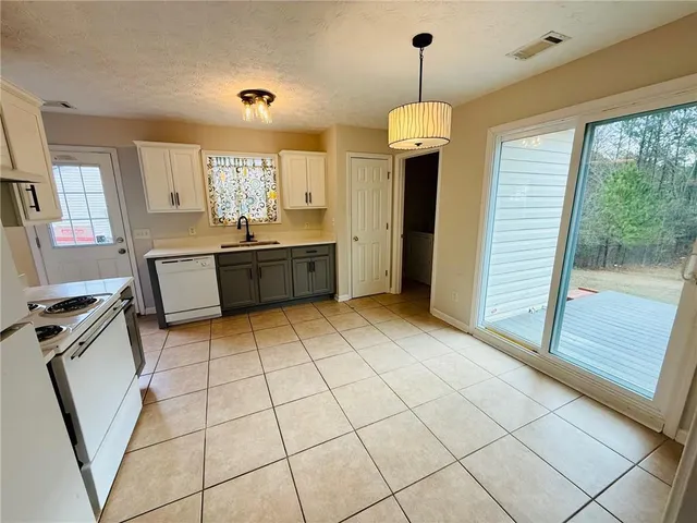 a kitchen with a sink a counter top space and appliances