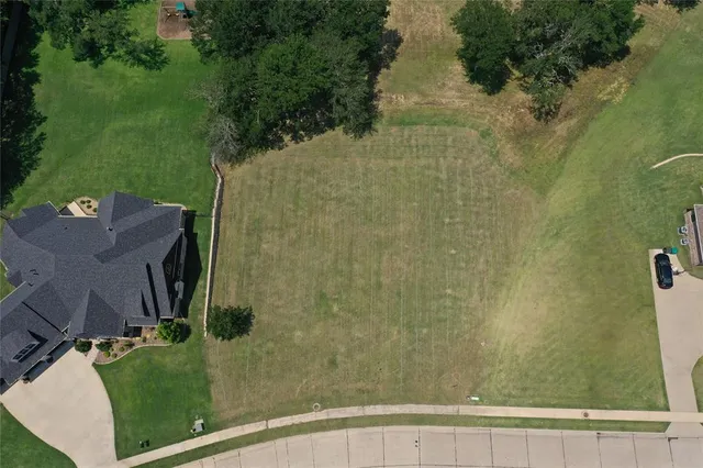 an aerial view of a residential houses with outdoor space