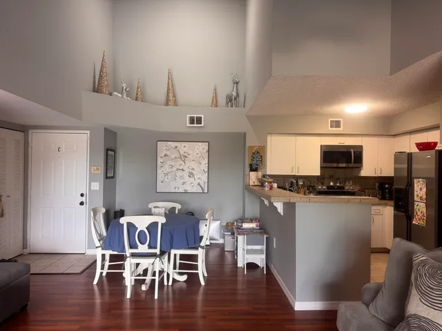 a view of a dining room with furniture and wooden floor