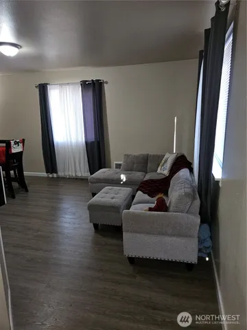 a living room with furniture and a chandelier