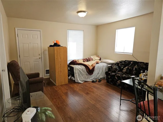 a bed room with furniture and wooden floor