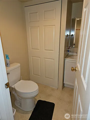 a white toilet sitting next to a shower