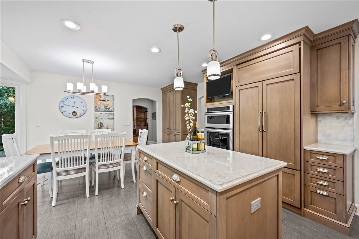 1985 Clavey Road Highland Park, IL 60035 - Photo 12 of 35 a kitchen that has a kitchen island wooden cabinets and stainless steel appliances
