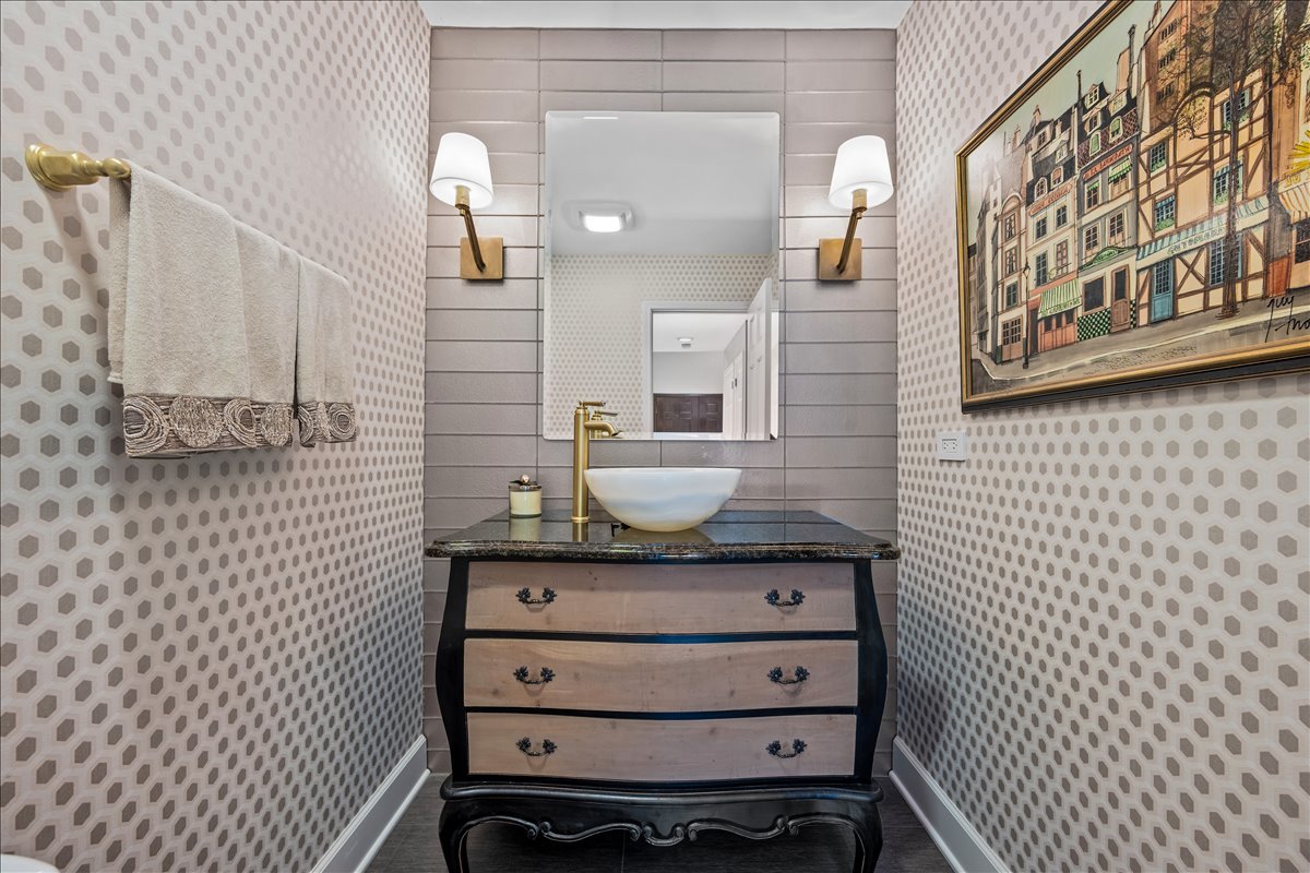 1985 Clavey Road Highland Park, IL 60035 - Photo 14 of 35 a bathroom with a granite countertop sink and a mirror