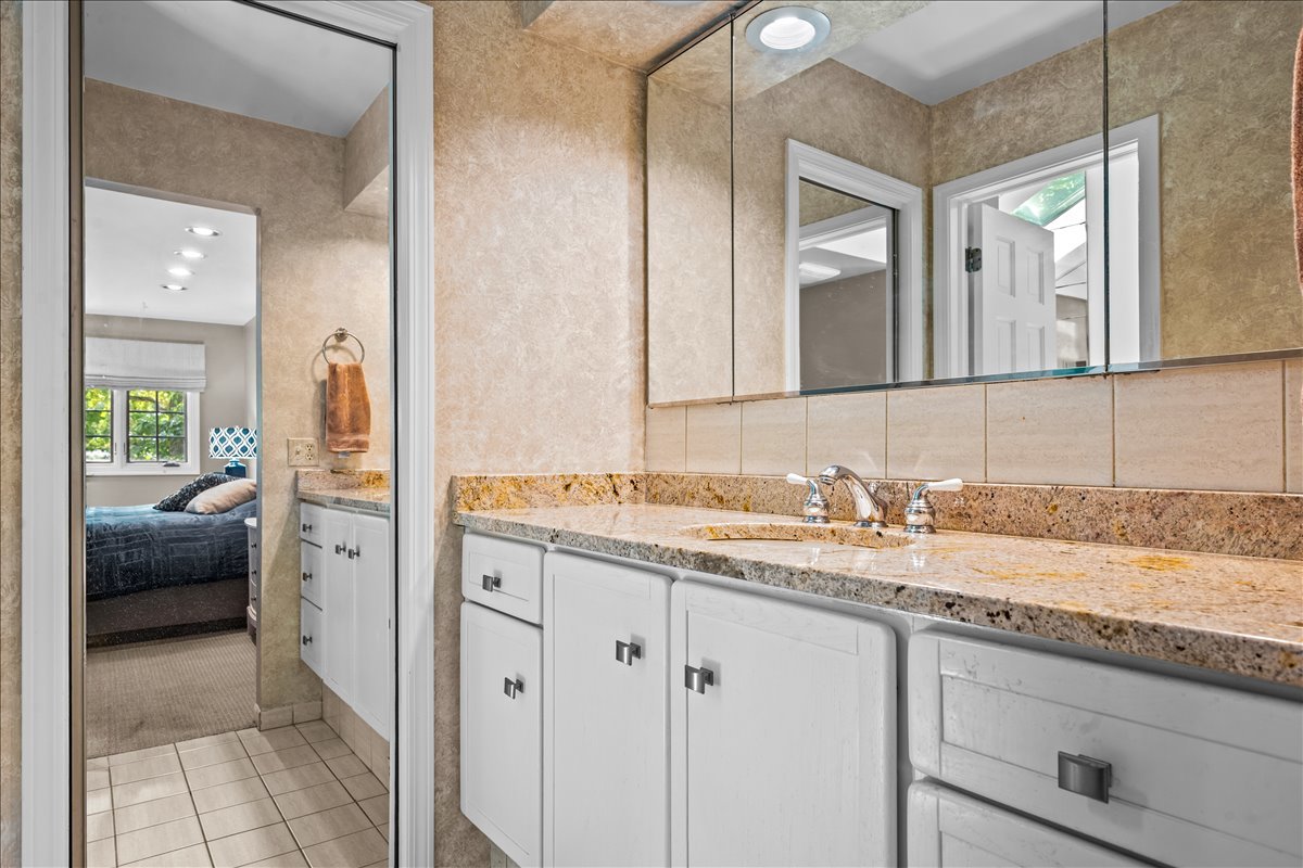 1985 Clavey Road Highland Park, IL 60035 - Photo 17 of 35 a en suite bathroom with a granite countertop sink and a mirror