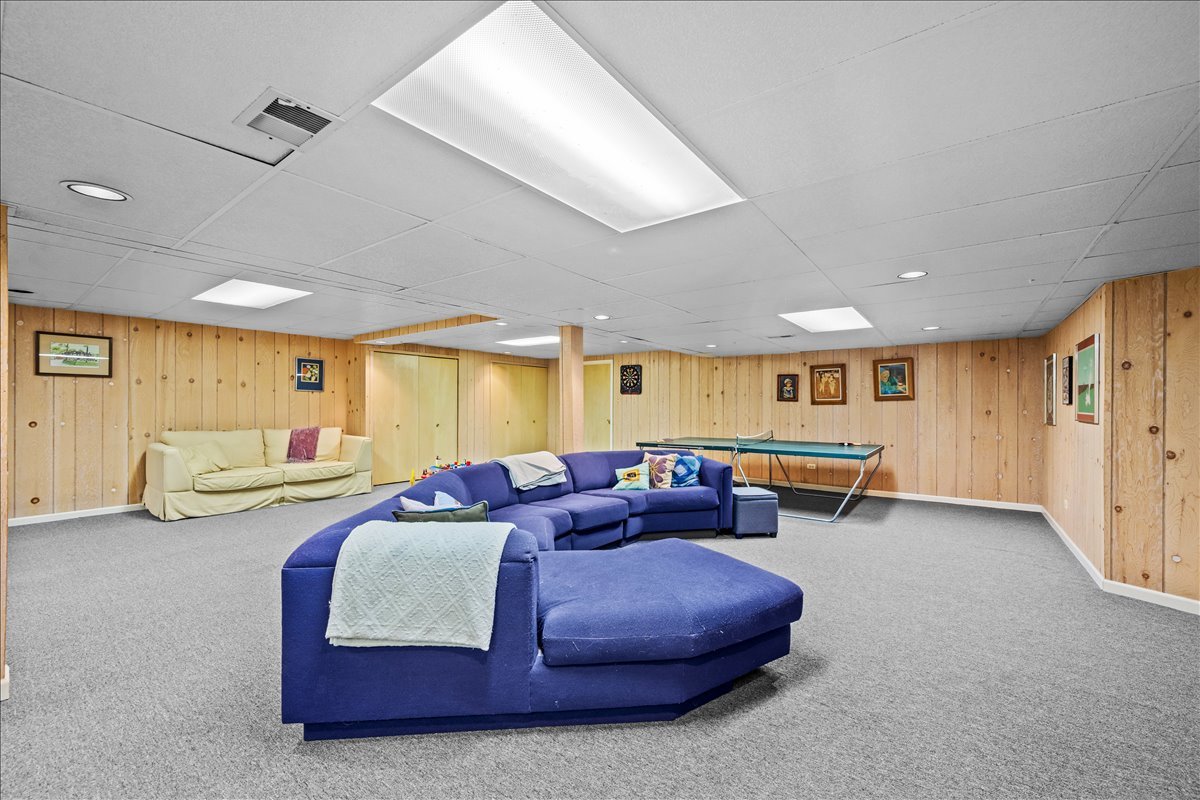 1985 Clavey Road Highland Park, IL 60035 - Photo 24 of 35 a spacious bedroom with a bed and a couch