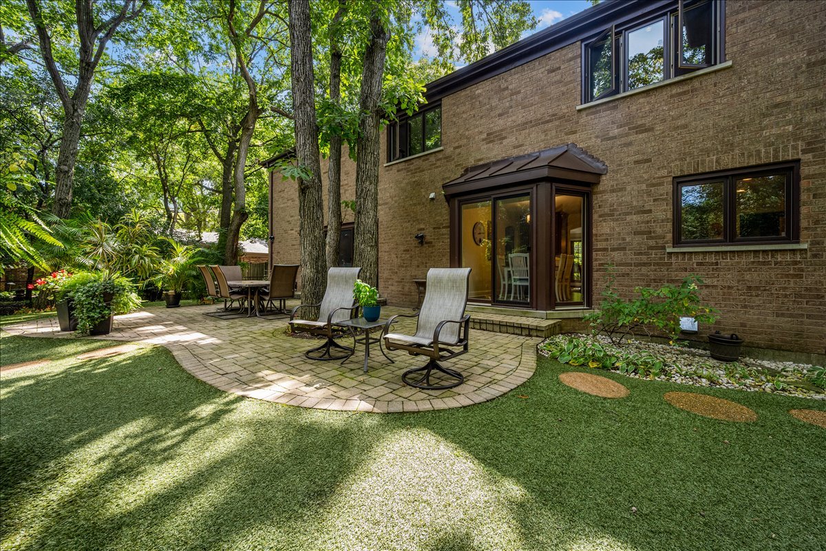 1985 Clavey Road Highland Park, IL 60035 - Photo 30 of 35 a view of a house with backyard sitting area and garden