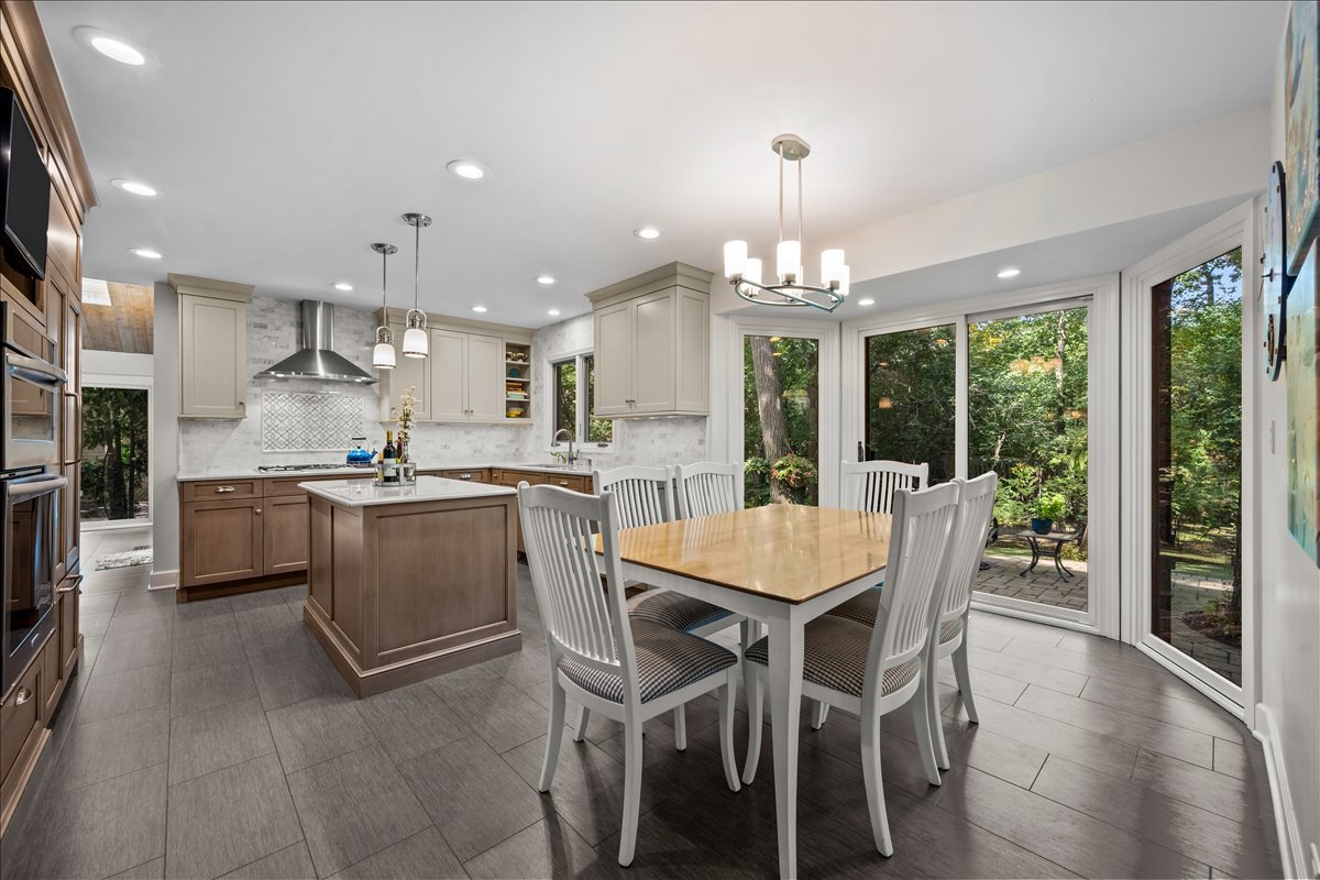 1985 Clavey Road Highland Park, IL 60035 - Photo 9 of 35 a kitchen with a dining table chairs stainless steel appliances and cabinets