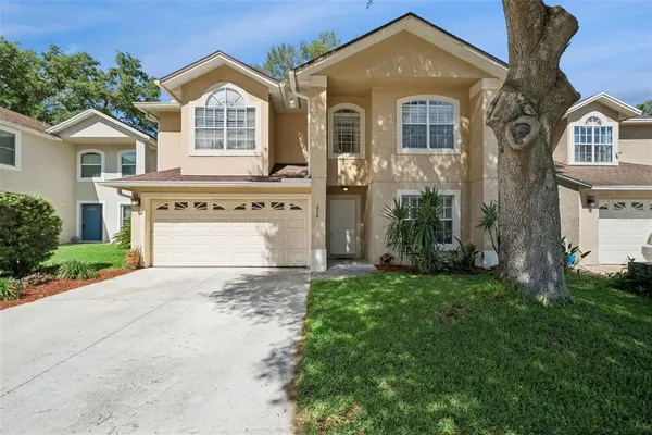 a front view of a house with a yard and garage