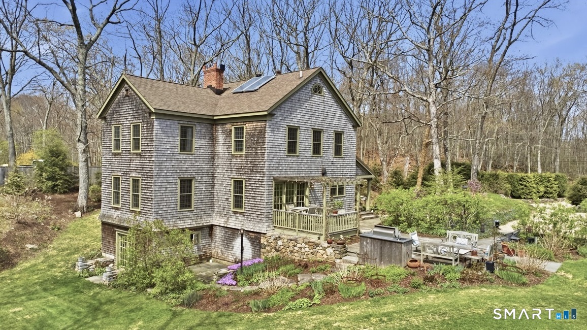 56 Gold Mine Road Roxbury, CT 06783 - Photo 3 of 40 Outdoor dining with trellis and stone patio featuring built-in grill with running water.