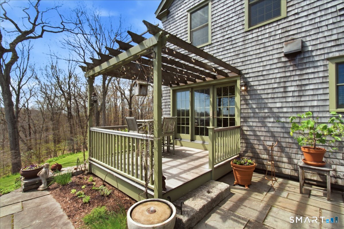 56 Gold Mine Road Roxbury, CT 06783 - Photo 33 of 40 Outdoor dining with trellis and french doors leading to indoor dining area.
