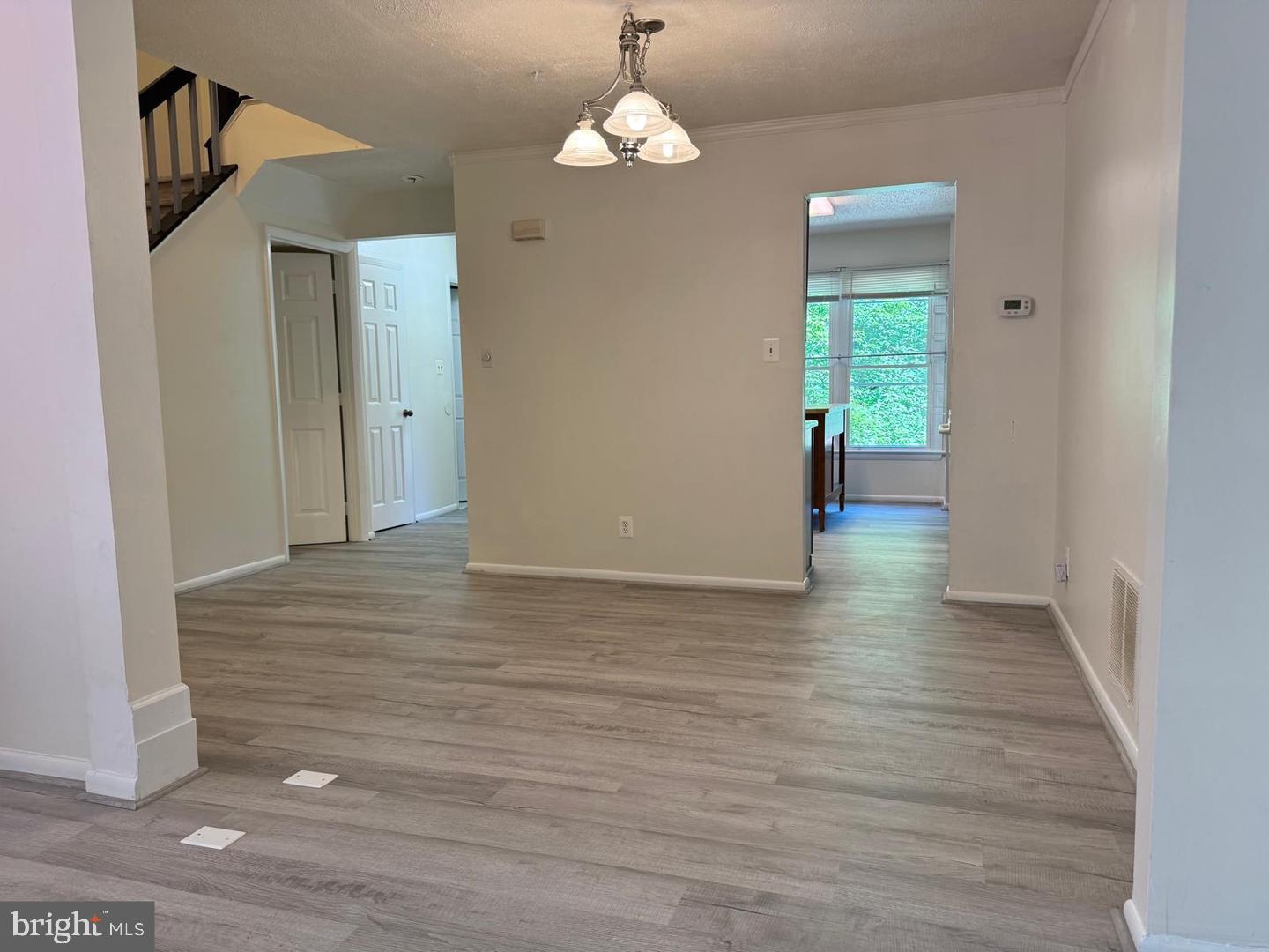 1631 Oak Spring Way Reston, VA 20190 - Photo 6 of 10 a view of a hallway with wooden floor and staircase