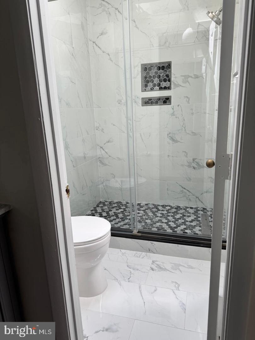 1631 Oak Spring Way Reston, VA 20190 - Photo 8 of 10 a bathroom with a toilet and a shower