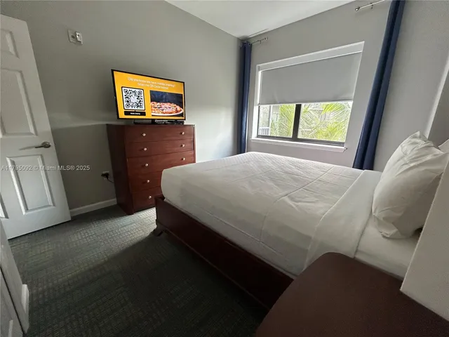 a bedroom with a bed and a television