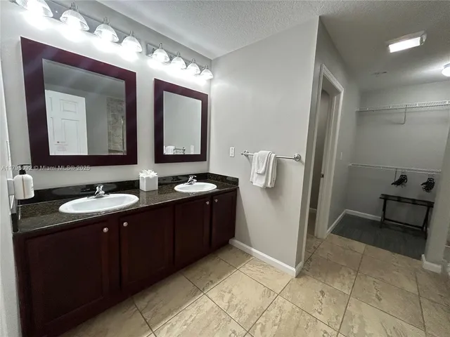 a bathroom with a double vanity sink and mirror