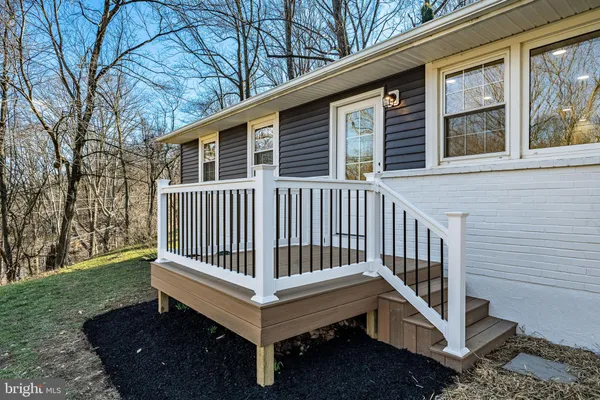 a view of a deck with a chair and wooden fence