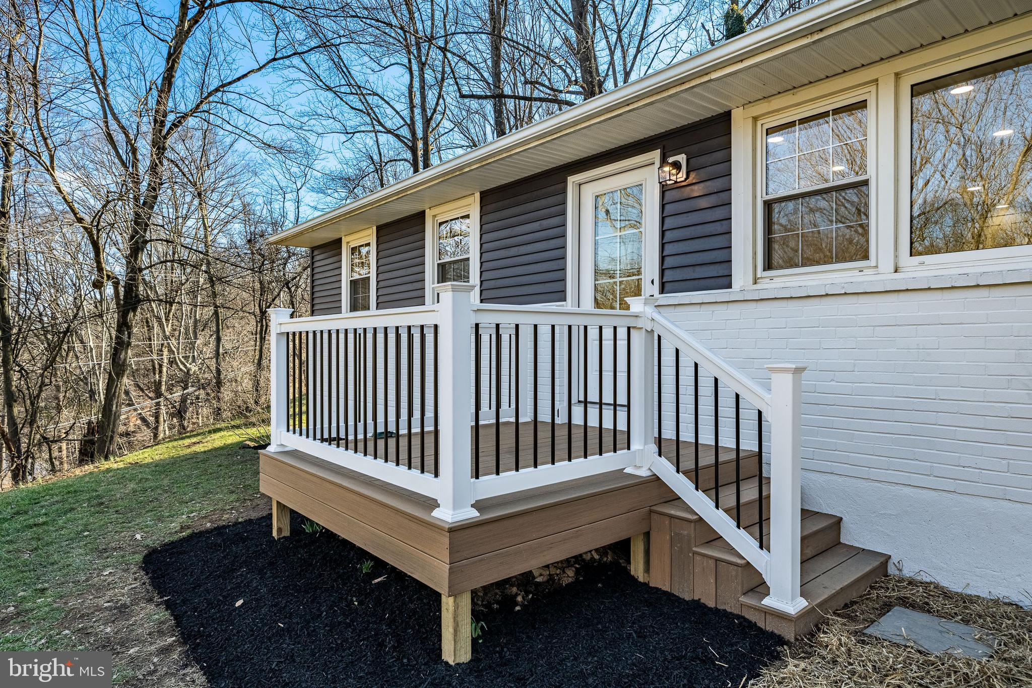 a view of a deck with a chair and wooden fence