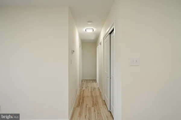 a view of a room with wooden floor and windows