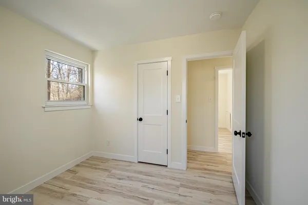 an empty room with wooden floor