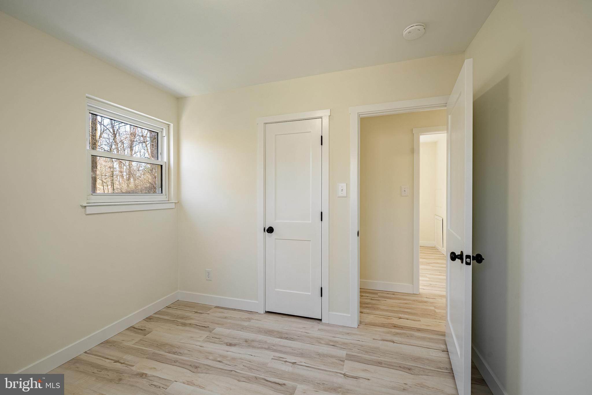 231 Laurel Bridge Road Landenberg, PA 19350 - Photo 19 of 57 an empty room with wooden floor and windows