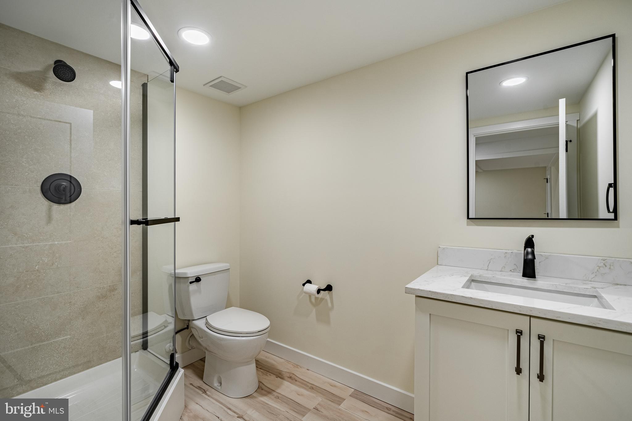 231 Laurel Bridge Road Landenberg, PA 19350 - Photo 29 of 57 a bathroom with a toilet sink a shower and mirror
