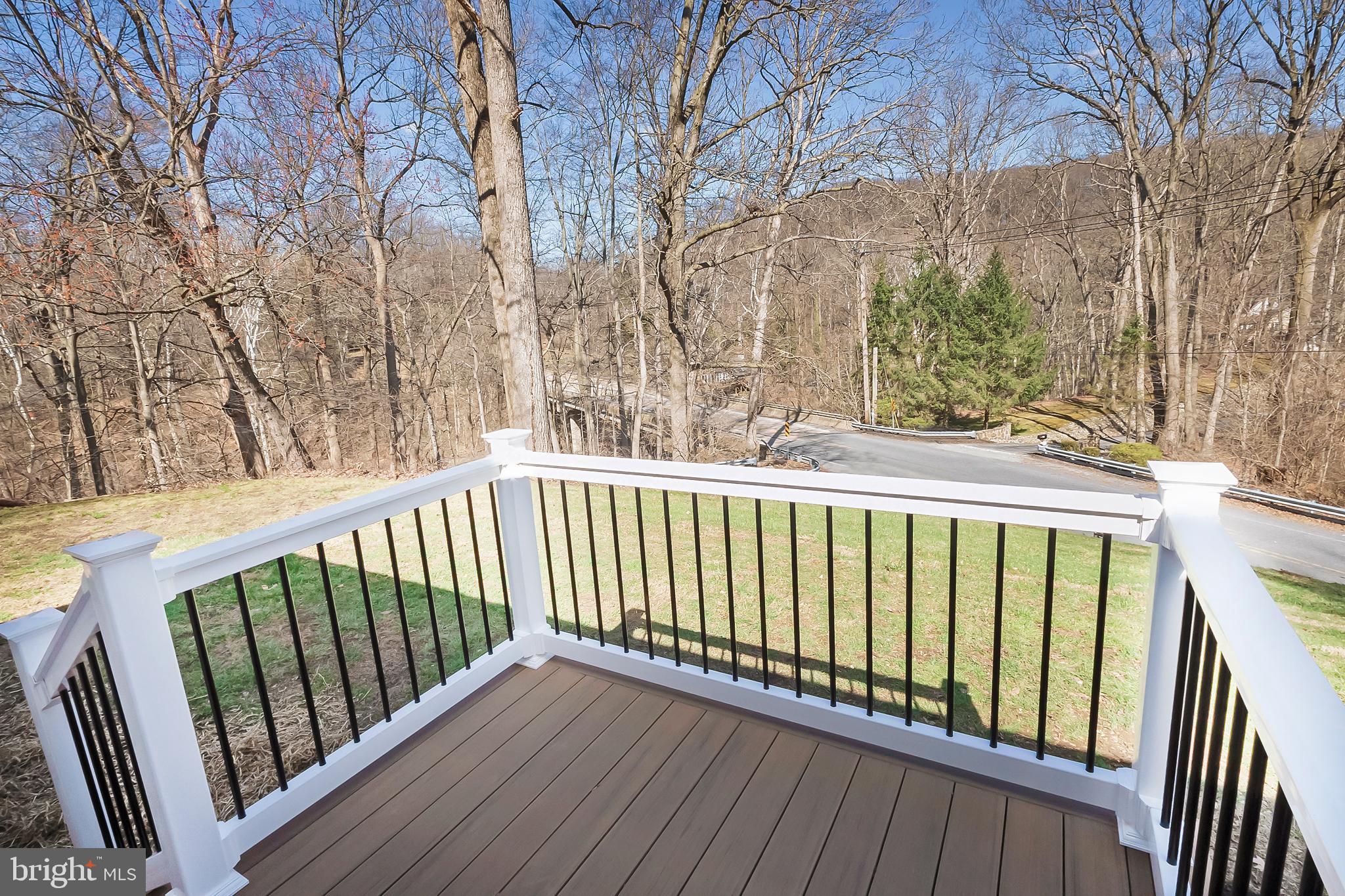 231 Laurel Bridge Road Landenberg, PA 19350 - Photo 35 of 57 a balcony with wooden floor and fence