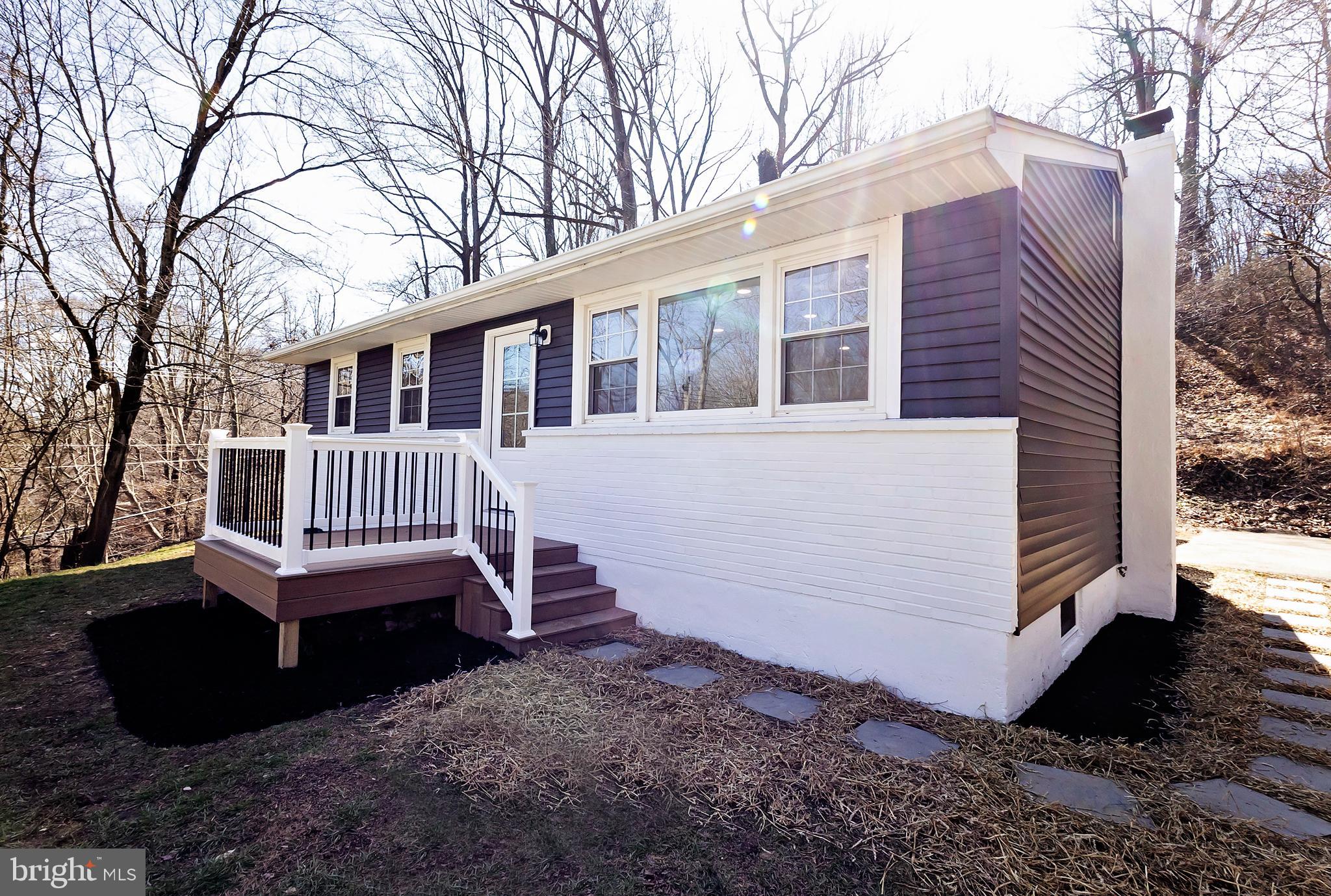 231 Laurel Bridge Road Landenberg, PA 19350 - Photo 46 of 57 a view of a house with a yard and deck