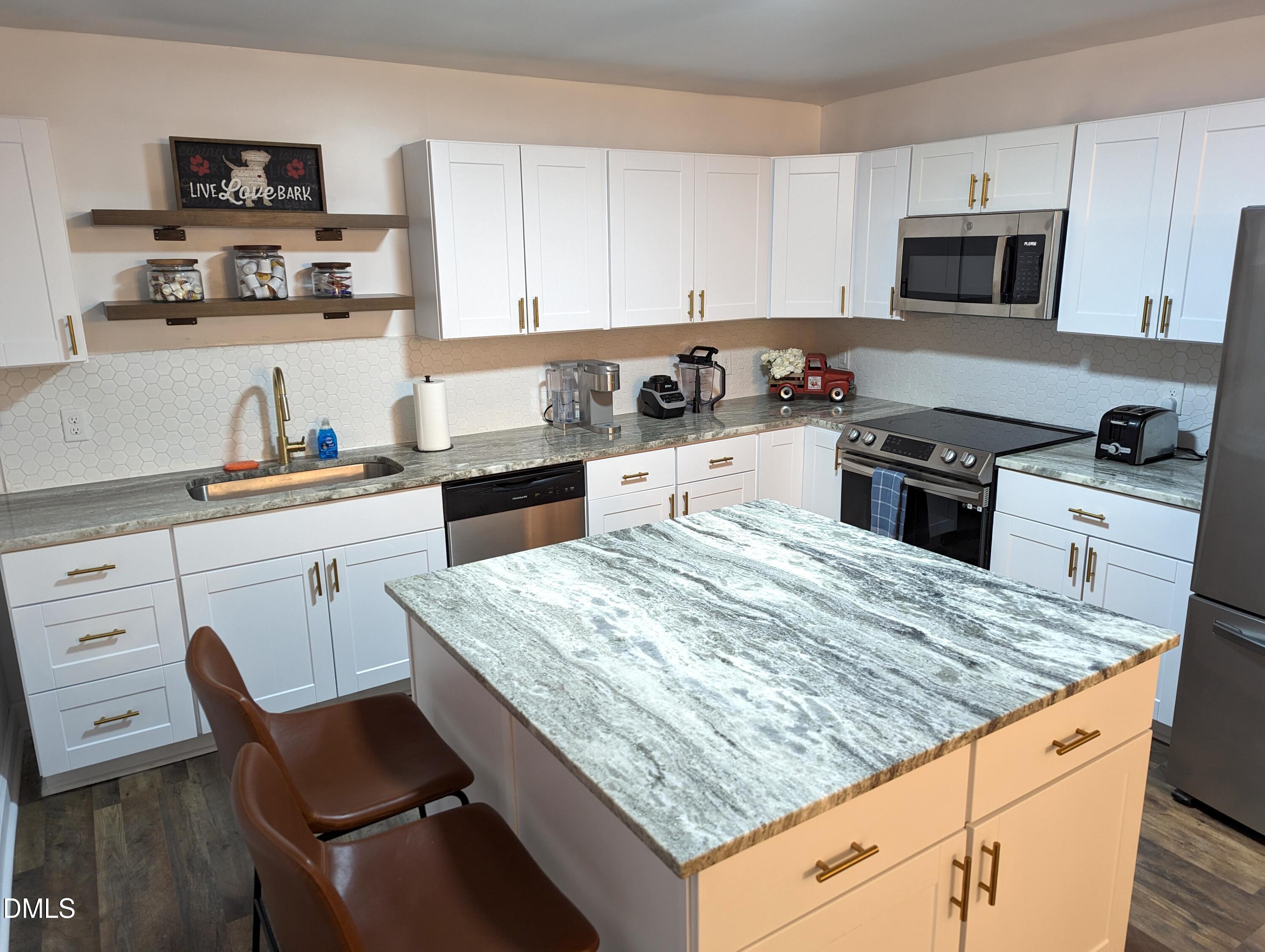 4816 Whitehall Avenue Raleigh, NC 27604 - Photo 5 of 23 a kitchen with granite countertop white cabinets sink and stainless steel appliances