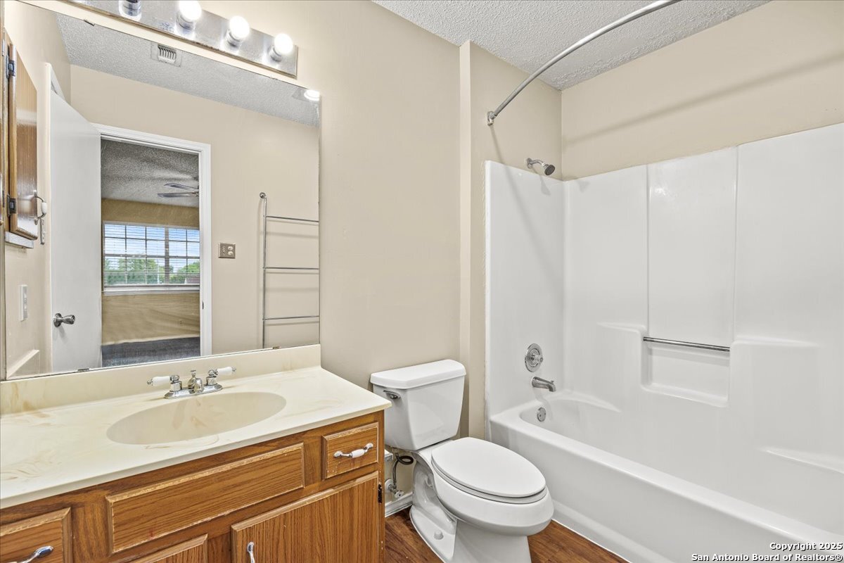 9140 Timber Path, Unit 1403 San Antonio, TX 78250 - Photo 15 of 24 a bathroom with a sink toilet tub and shower