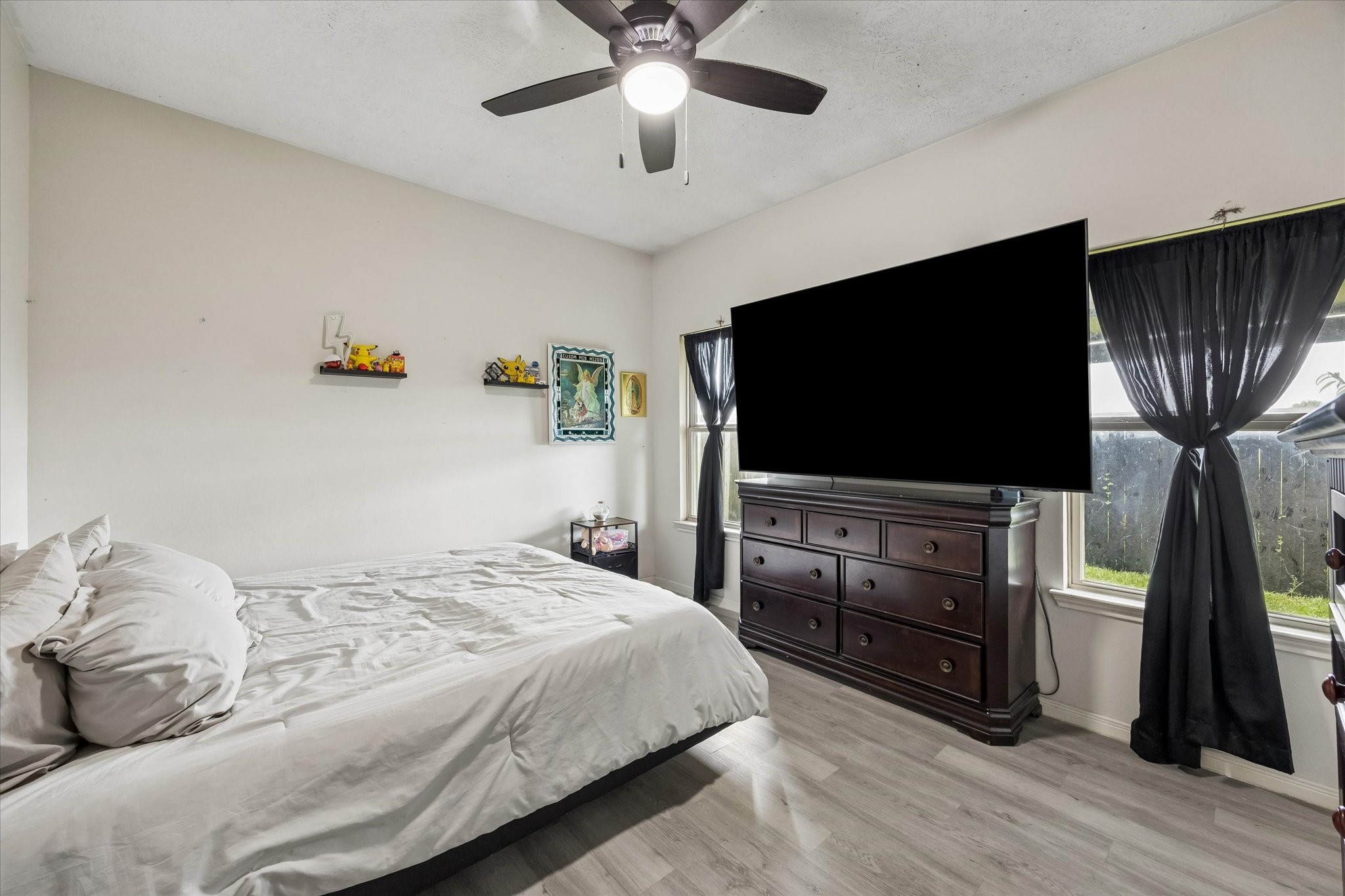 1741 Eagle Lake Road Sealy, TX 77474 - Photo 8 of 15 a bedroom with a bed and a flat screen tv