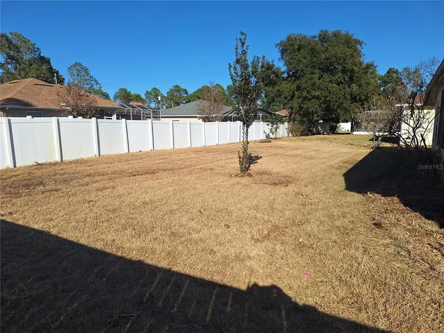 a view of a backyard of the house