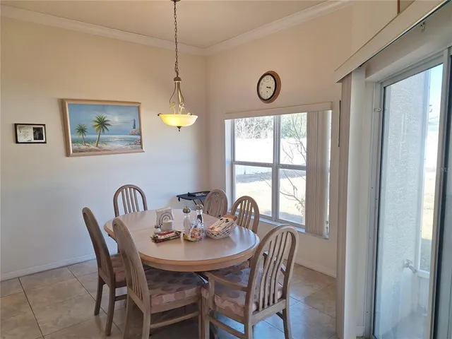 a dining room with furniture a rug and a window