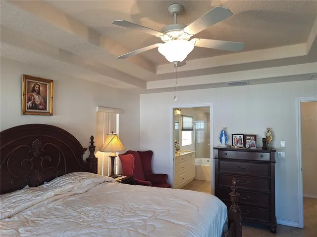 a bedroom with a bed and dresser with mirror