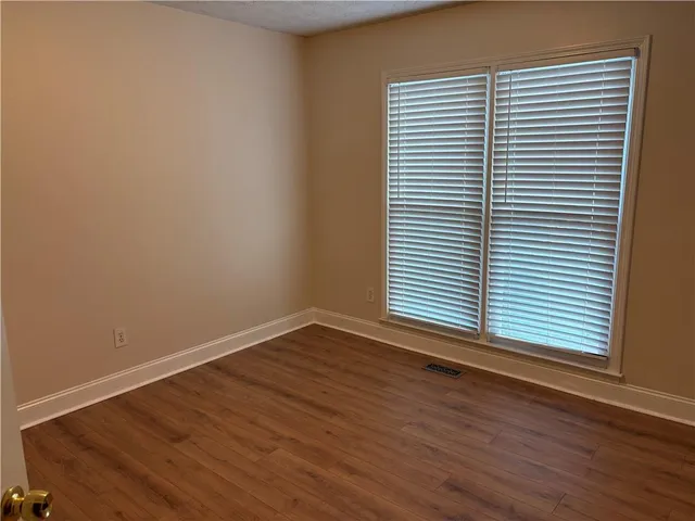 an empty room with wooden floor