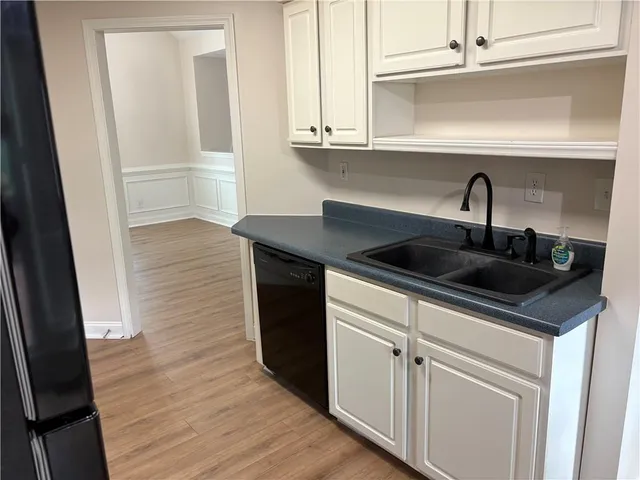 a kitchen with granite countertop a sink and cabinets