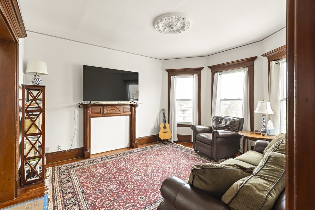 55 Main Street Somerville, MA 02145 - Photo 7 of 28 a living room with furniture and a flat screen tv